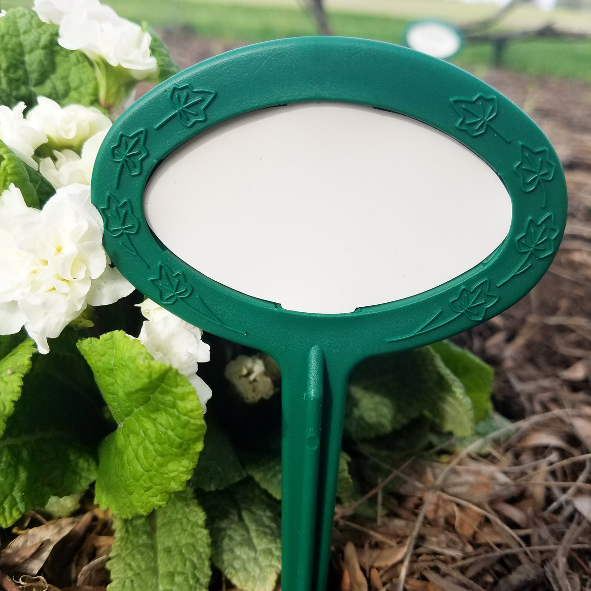 Garden marker  long lasting Made in USA. Photo features plant marker by a primrose. 