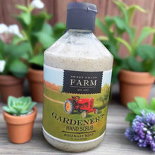 Load image into Gallery viewer, 16.9 oz Gardener&#39;s Hand Scrub Rosemary Mint scented. Shown with a floral background. 
